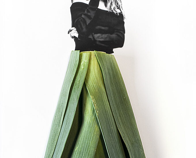 photograph of model Doutzen with a dress of leek leaves
