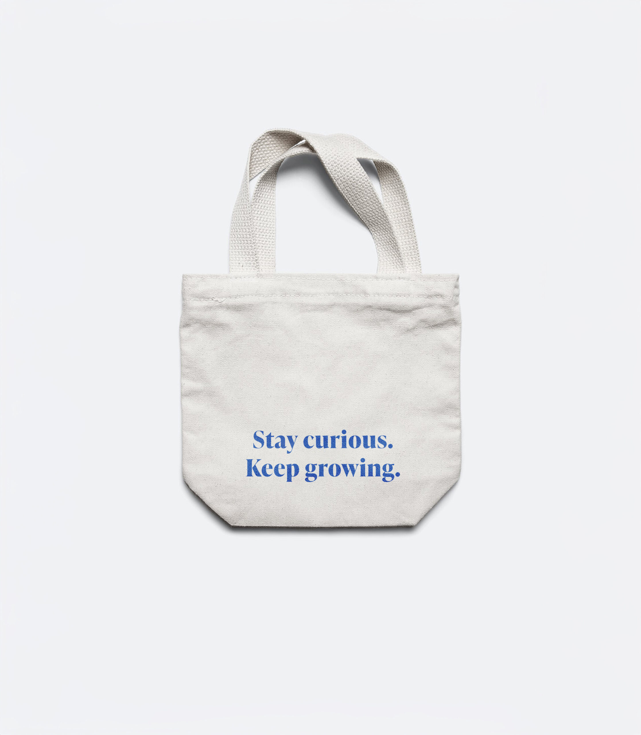 tas met opschrift: Stay curious. Keep growing.